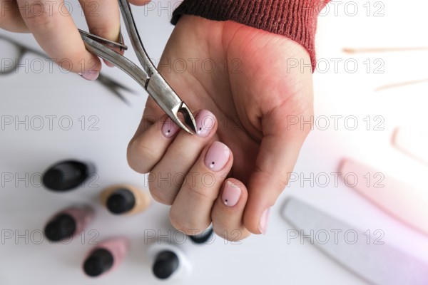 Woman hands, nail polish, manicure tools table top view flat lay. How to do manicure at home concept. Do manicure by yourself staying at home. Self care. Nude nails. Spa, medicine advertisement. Beauty