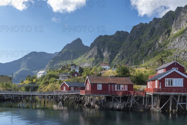 Village scene with traditional fishermen's houses, the so-called rorbuer, in the background the landscape of the Lofotodden National Park, A i Lofoten, Moskenesoy, Lofoten, Norway