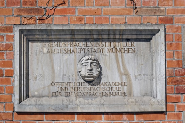 Information sign with Janus head, Foreign Language Institute of the state capital in Amalienstraße, Munich, Upper Bavaria, Bavaria, Germany