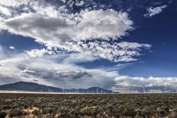 Wind turbines and wild thunder and rain clouds over the Great Basin Highway US 93, between Ely and Baker, Nevada, USA