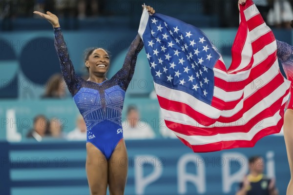 Simone Biles (USA) of the United States celebrates with the fans after winning the Artistic Gymnastics Women's All-Around Final at the Bercy Arena during the 2024 Paris Summer Olympics in Paris, France