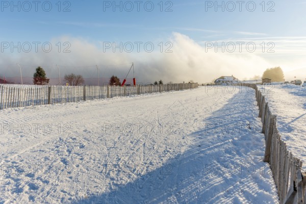 Cross-country ski trail in the snowy mountain on a sunny day. France, Vosges