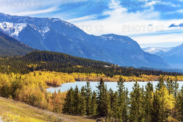 Rocky Mountains of Canada. Mountain peaks covered with glaciers and snow. This artificial Abraham lake. Picturesque multicolor autumn landscape