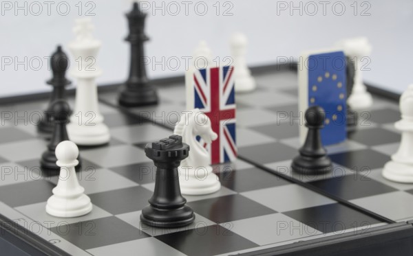 Chess pieces and flags of the European Union and the UK on a chessboard. The concept of the political game and chess strategy Brexit