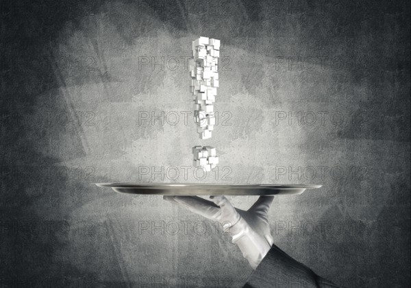 Cropped image of waitress's hand in white glove presenting multiple cubes in form of exclamation mark on metal tray