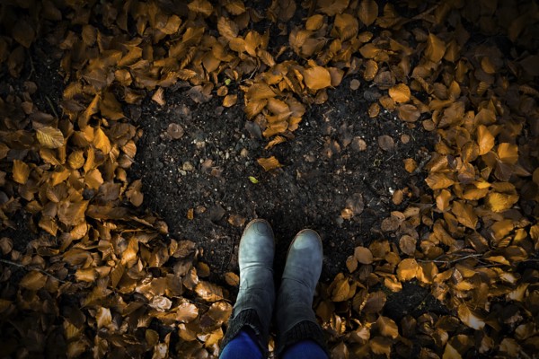 Heart-shaped pattern in the foliage on the ground, surrounded by boots in autumn forest, Hasbruch 27798 Hude-Germany