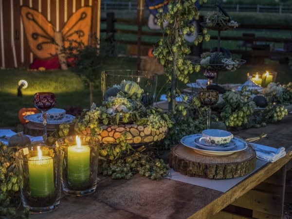 Rustically decorated table with candles and crockery in a natural and cosy atmosphere, borken, münsterland, germany