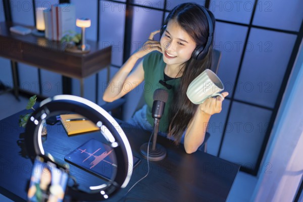 Content creator Young asian woman influencer creating content in home studio entertainment and communication blogger video record with smartphone for online vlog