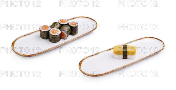 Food, A sushi platter displays an array of vibrant rolls with fish and vegetables alongside a distinct block sushi piece. The setting highlights the meticulous presentation of Japanese cuisine