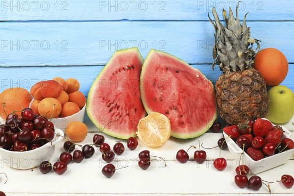Summer berries and fruits on wooden background, healthy natural food concept, breakfast with ingredients, top view, advertisement for a store, business card for a cafe, invitation with place for text, selective focus