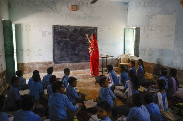 Teacher teaching students in school class room, Jaisalmer, Rajasthan, India, Asia