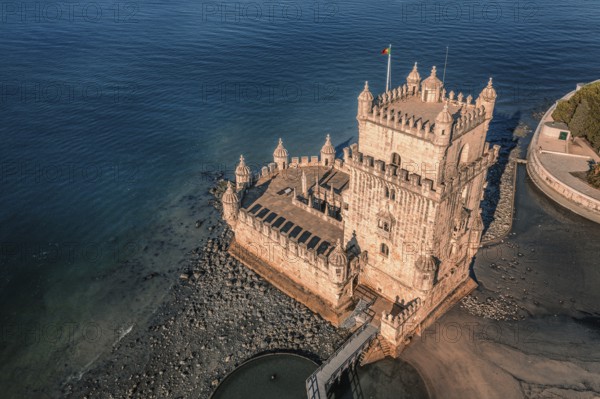 Aerial image of Belem tower, Lisbon, Portugal at summer day. Medieval fortification on Tagus river in late Gothic or Manueline style, UNESCO world heritage site, Age of Discoveries, tourist attraction, Portuguese seafaring history