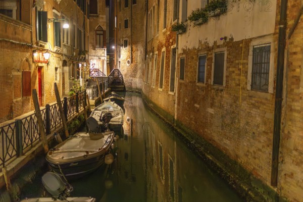 Boats in a canal in the historic centre, night shot, Venice, Italy