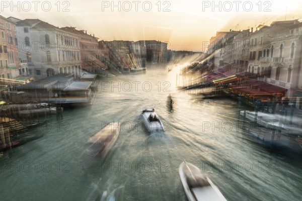 Evening light at sunset, view over the Grand Canal, gondola and boats, from the Rialto Bridge, zoom effect, Venice, Veneto, Italy