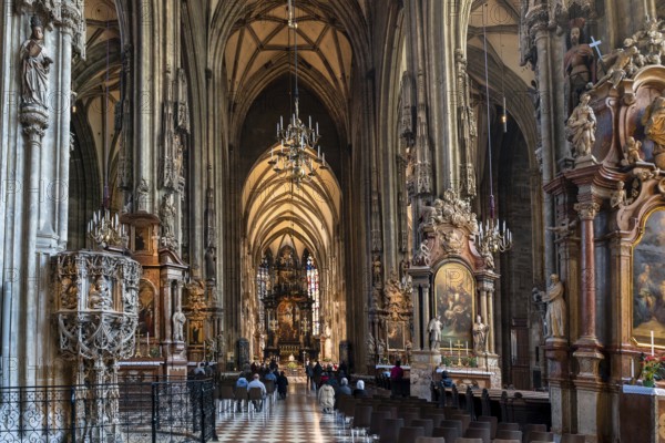 Vienna, Austria, 22 September, 2022: view of the central nave and altar during morning church service inside the historic St. Stepehen's Cathedral in Vienna
