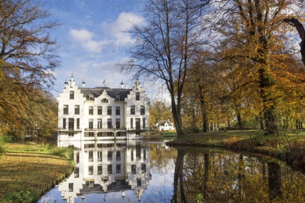 Castle Staverden reflecting in the moat and surrounded by autumn colored trees