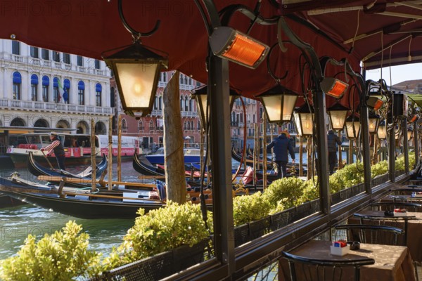 View of the Grand Canal, Rialto Bridge, and gondolas from outdoor restaurant seats, Venice, Italy