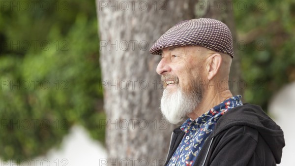 An image of an old man with a beard outdoor