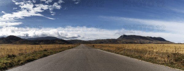 A country highway leading into the distance in the Gran Sasso and Monti della Laga National Park in the Apennine mountains of Italy