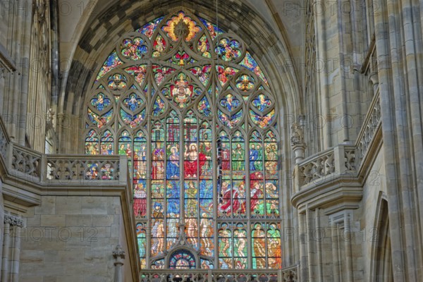 Gothic cathedral with a colorful, intricate stained glass window and open arches allowing light in, UNESCO World heritage site, Cathedral of Saints Vitus, Prague, Czech Republic