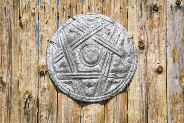 Old Shield on the Wooden Fence