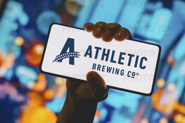 In this photo illustration, the Athletic Brewing Company logo is displayed on a smartphone screen