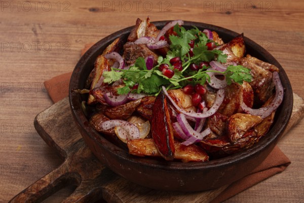 Ojakhuri, a traditional Georgian dish, fried potatoes with meat, in a clay pan, top view, without people, homemade