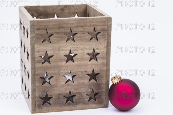 The photo shows a lantern with a red Christmas bauble