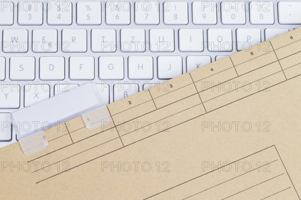 The photo shows a white keyboard with a briefcase