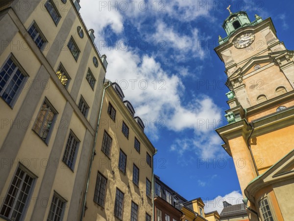 Historic buildings and church tower under blue sky with clouds, stockholm, baltic sea, sweden, scandinavia