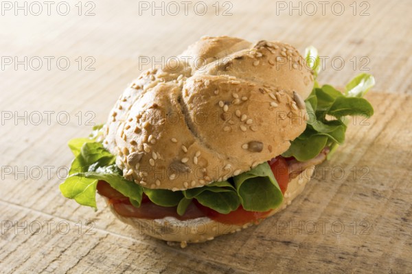 Sandwich with fresh smoked meat, cheese, lettuce and tomato with homemade ketchup