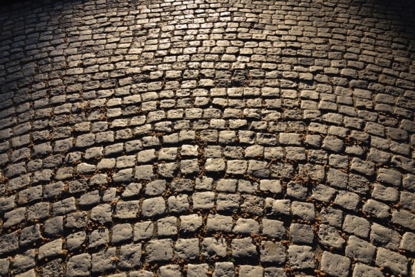 Gloomy old cobblestone pavement. Beautiful stone background