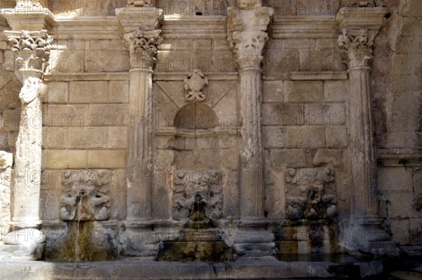 Old stone fountain in the campaign on the Cretan