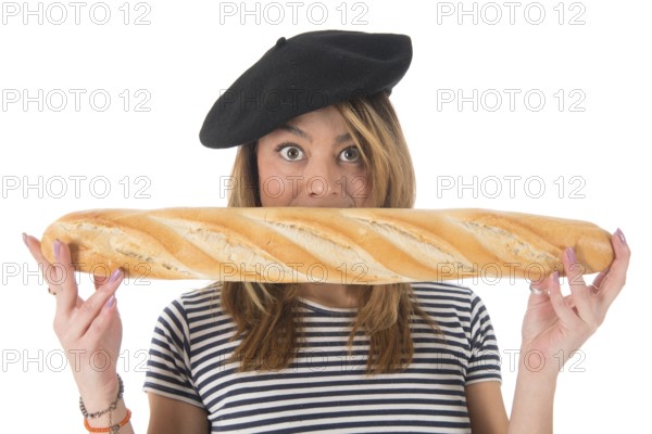 Young French girl with typical French barret and striped shirt eating bread isolated over white background