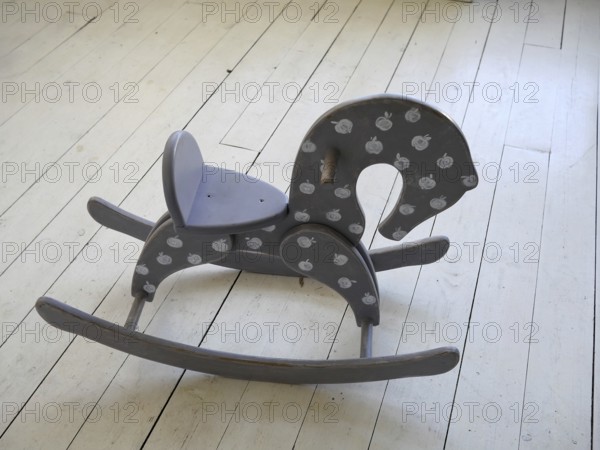 Wooden horse on the floor in vintage interior