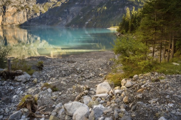 Oeschinensee lake in Switzerland in autumn, landscape photography, crystalic blue water, trees
