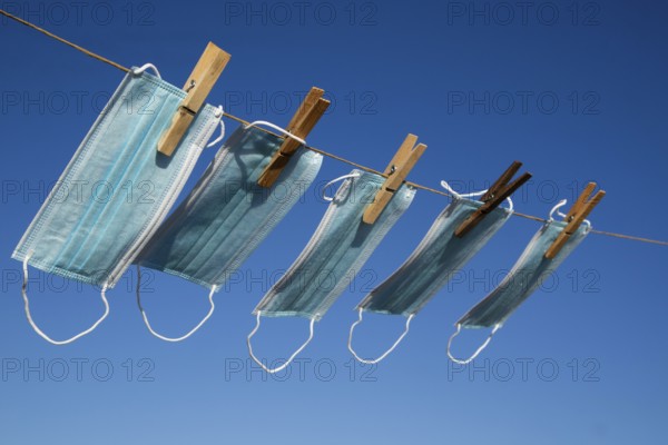 Photographic representation of the recovery of the anti Covid-19 masks washed and hung out in the sun to dry