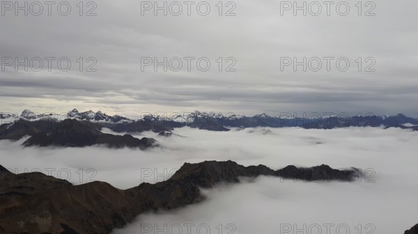 Fog fills the valleys below the Neblehorn in the Allgäu