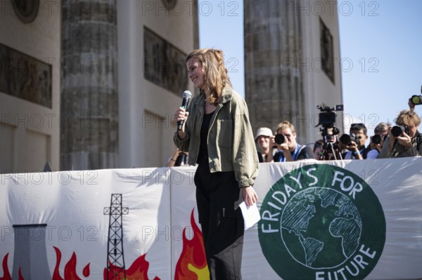 15/09/2023, Berlin, Germany, Europe, German climate protection activist Luisa Neubauer during her speech on a stage in front of the Brandenburg Tor in Berlin's Mitte district at the global climate strike organised by the Fridays for Future movement under the motto