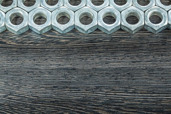 Stainless nuts on wooden board