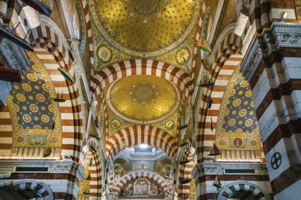 View inside the Basilica of Our Lady of the Guards and golden paintings on religious themes, catholic christian religion