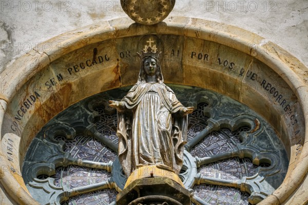 Close-up of a round church window with a saint sculpture Sanctuary Caraça, Minas Gerais, Brazi