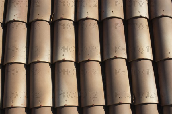 Tiles on old castle roof, architecture background. Brown roof tiles
