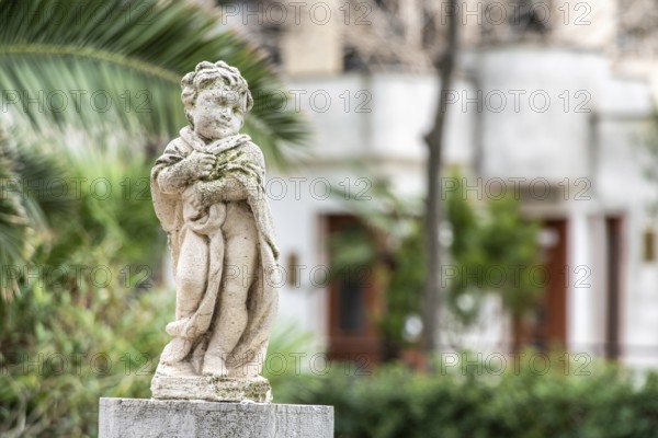Baroque sculpture of a child in a park in Trani, Southern Italy