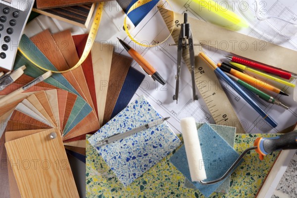 Architect or interior designer workplace desk and design tools with lots of construction material samples