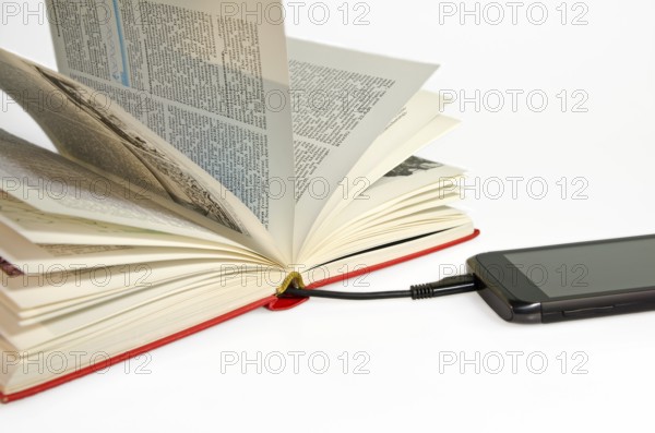 Smartphone connected to a book via USB cable