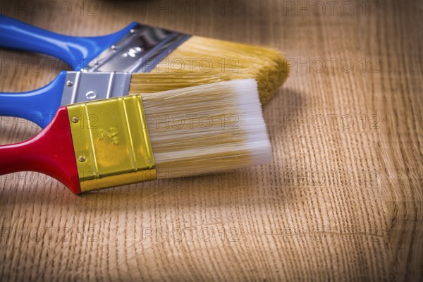 Very close up view on stack of three paint brushes