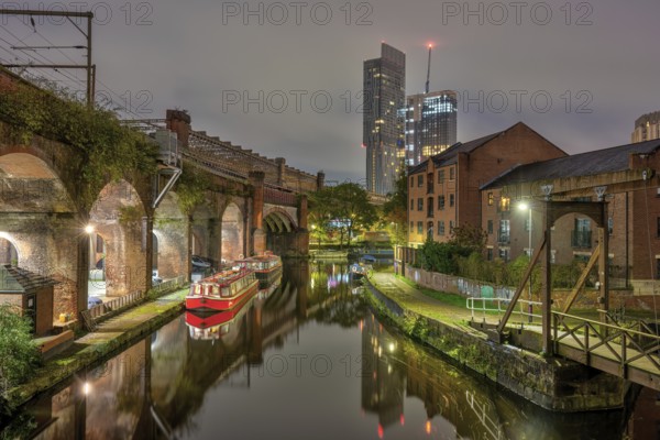 Castlefield in Manchester, Great Britain, at night, with a modern skyscraper in the background