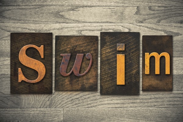 The word SWIM written in wooden letterpress type