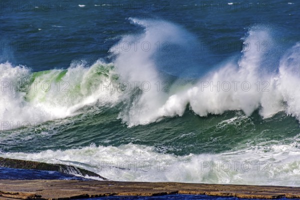 Big, dangerous waves during tropical storm in the green and blue waters of Rio de Janeiro, Brazil